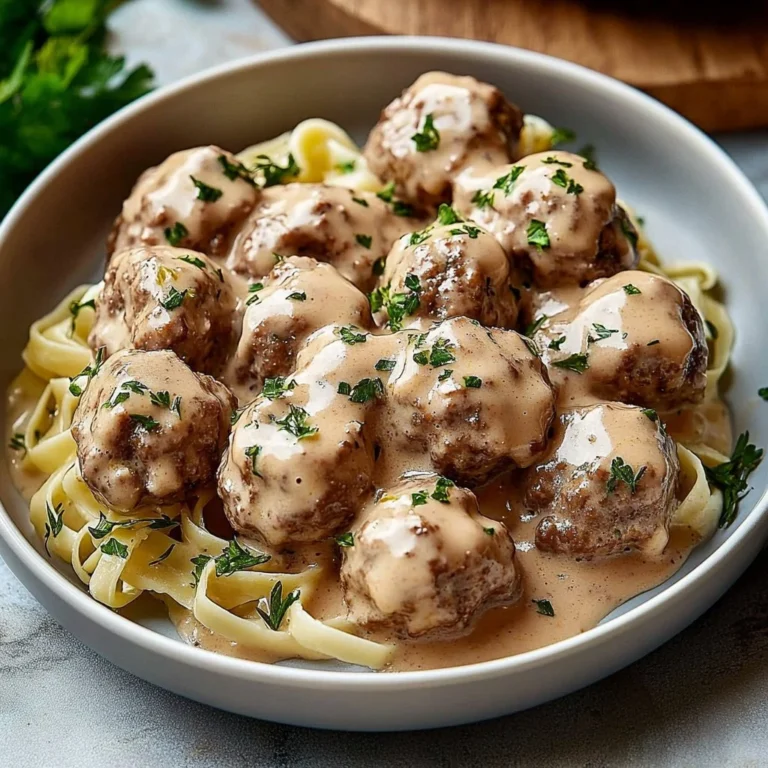 Delicious crockpot Swedish meatballs served with sauce and herbs.
