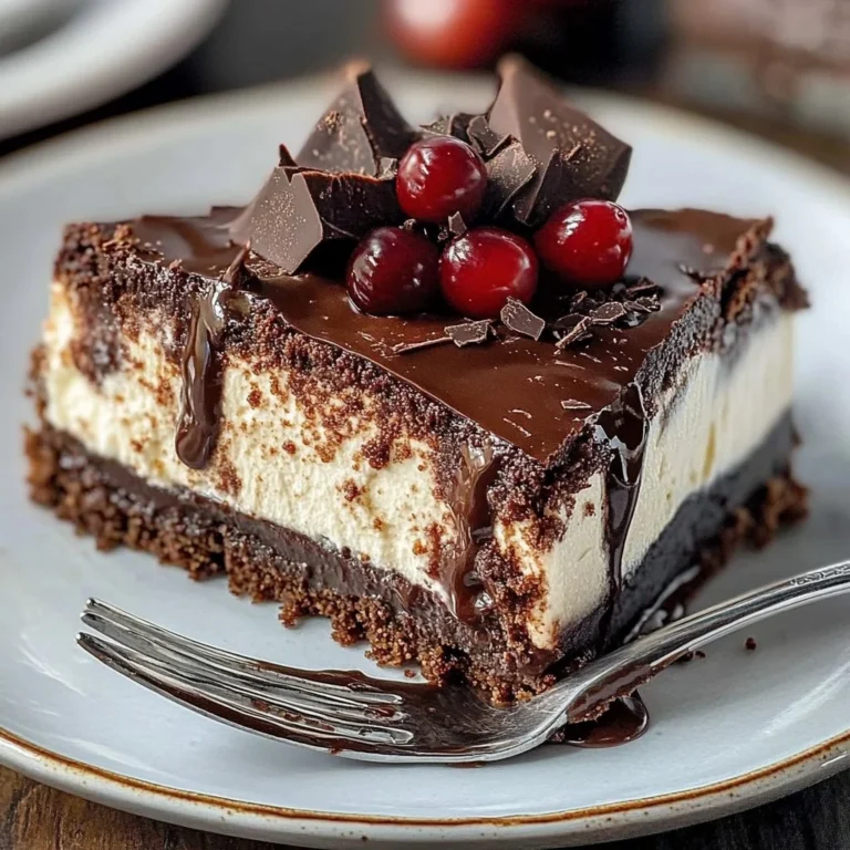 Decadent hot fudge sundae cheesecake topped with brownie and whipped cream