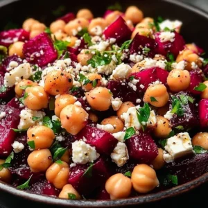 Chickpea salad with beet and feta served in a bowl